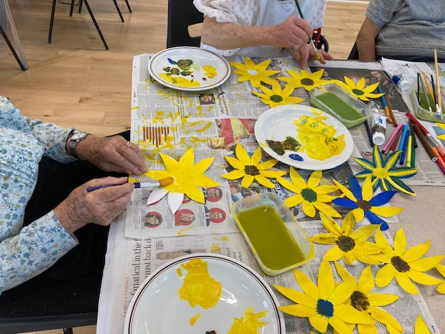 Memory Cafe patrons making Easter decorations